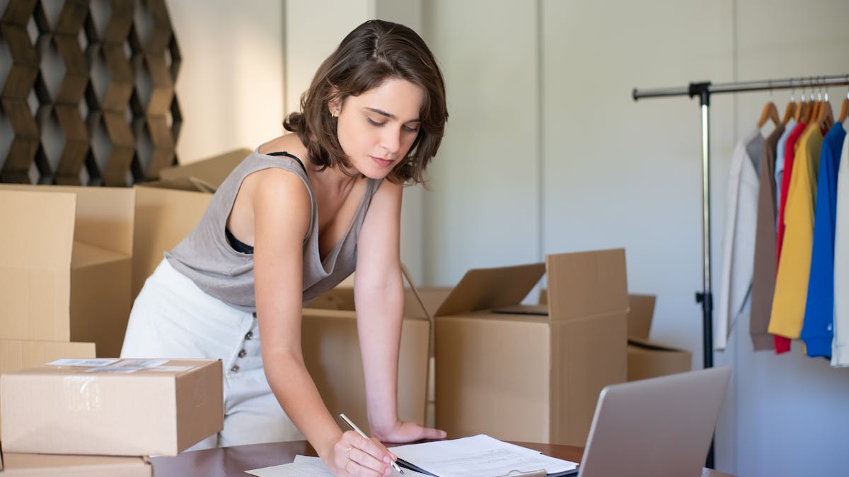 Small business owner managing online orders from a home office workspace